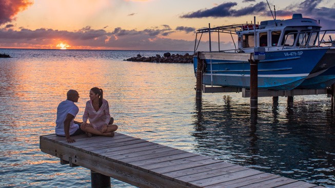 couple on boardwalk at sunset